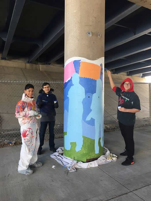 AMS students working on the mural